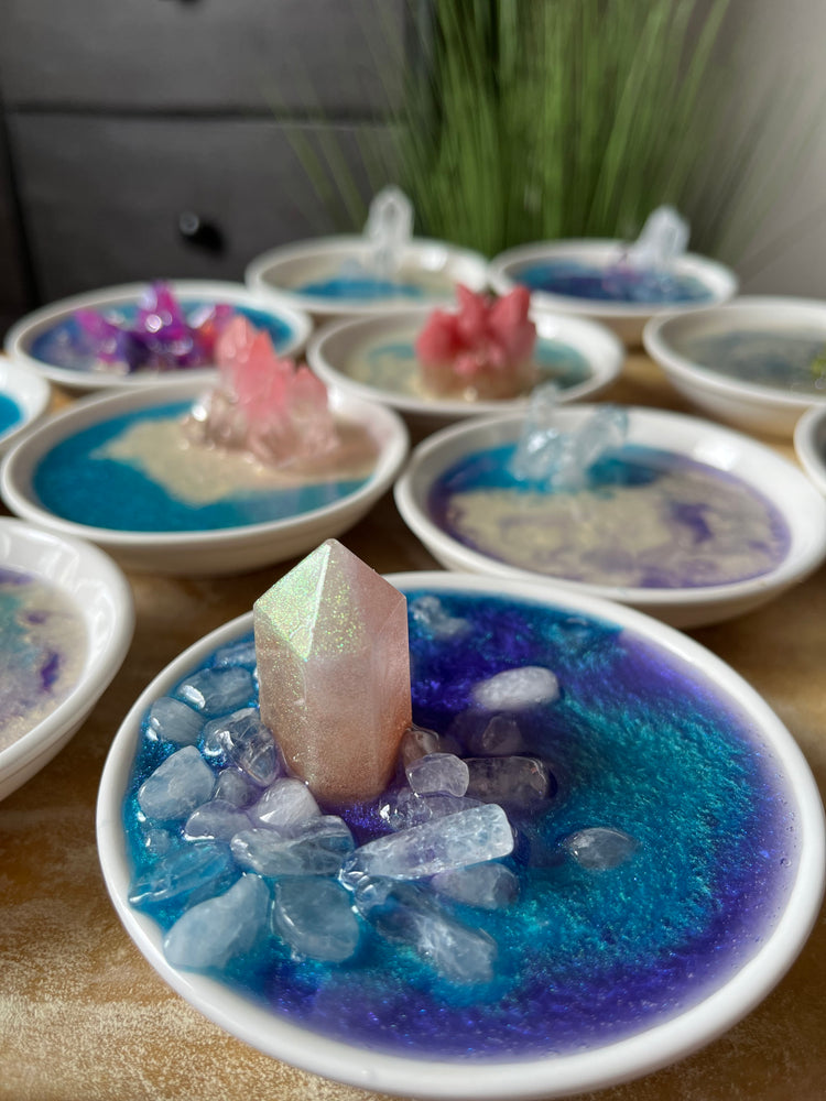 eight different ring trays gathered together all with different crystals and colors of blue cream white pink purple clear both epoxy crystals and real quartz