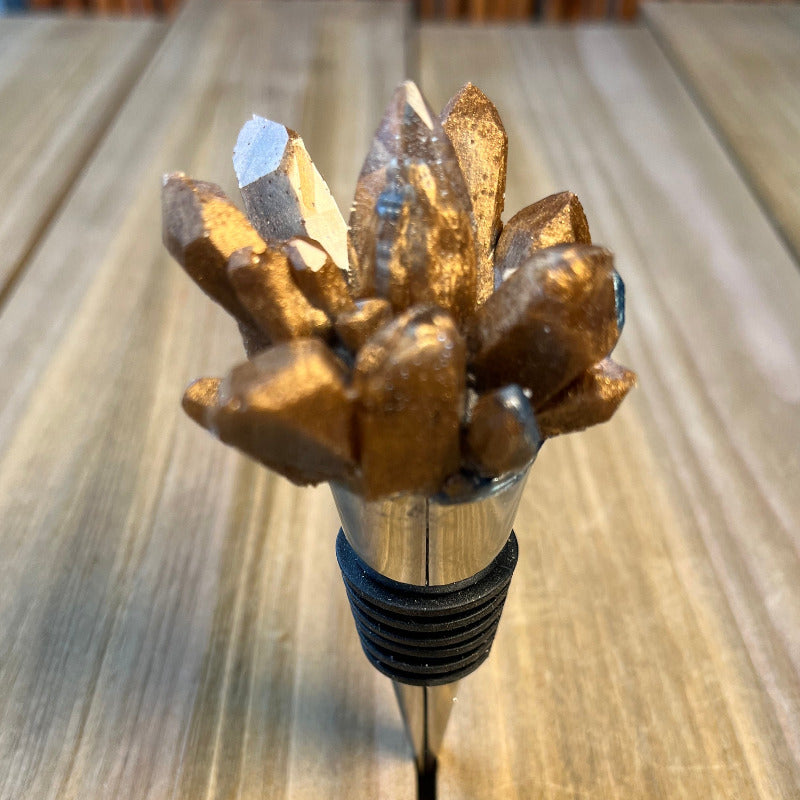 Silver metal stopper topped with a gold crystal cluster 