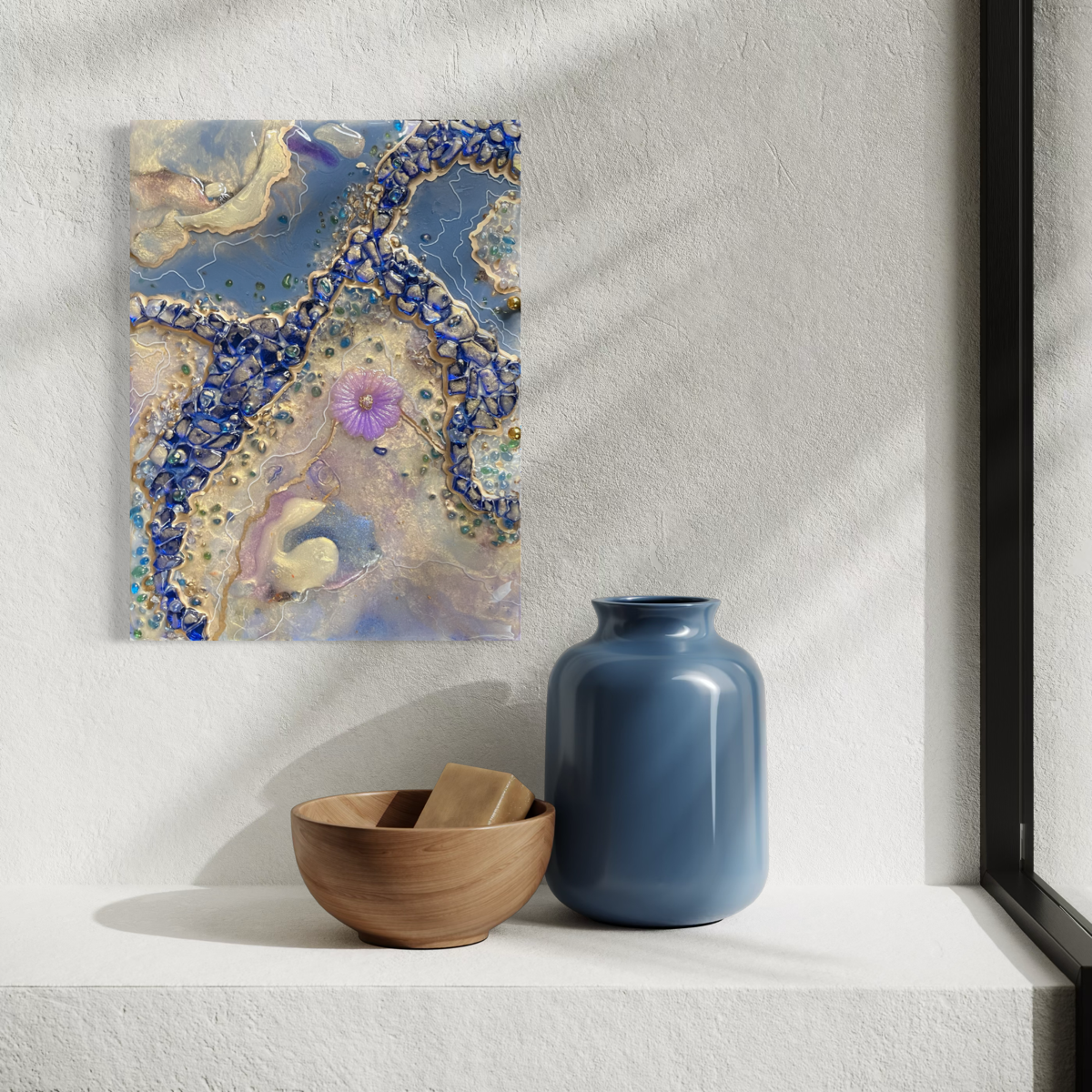 Epoxy resin geode abstract of pearl and blue colors with a purple flower in center hanging on a white wall