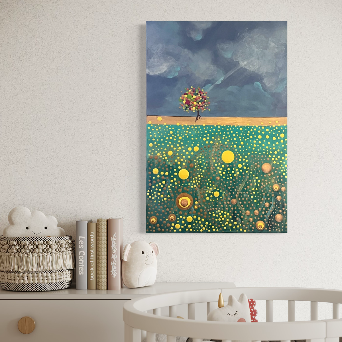 A vertical canvas painting depicting a surreal landscape with a small flower-blossomed tree on a golden path under a cloudy blue sky, above a green and yellow canola field hanging on a living room wall